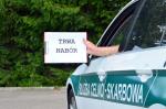 samochód służby celno-skarbowej, dłoń trzyma tabliczkę z napisem: nabór trwa